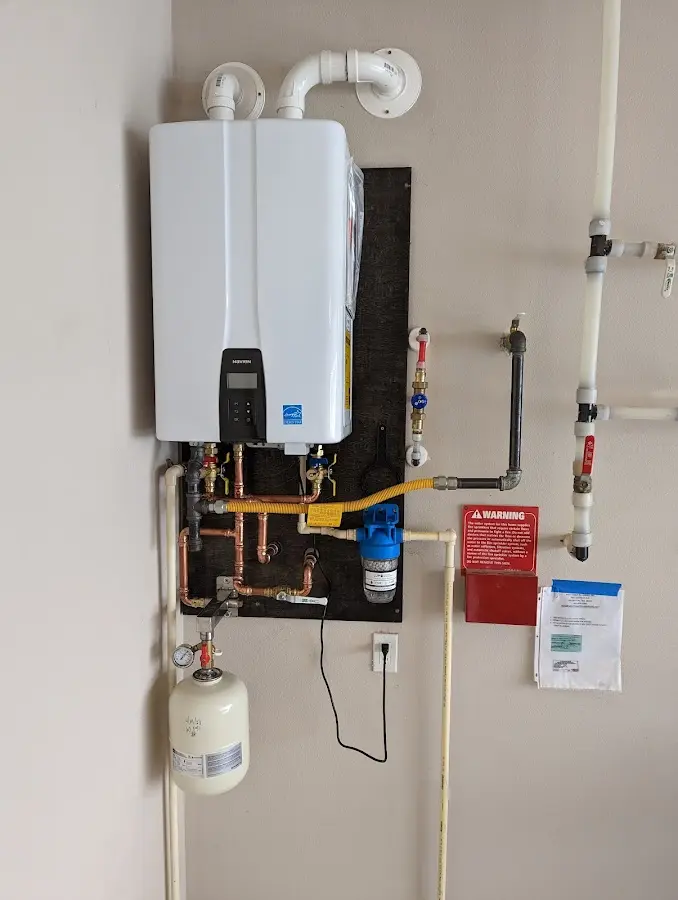 Professional plumber installing copper piping in a East Manchester home